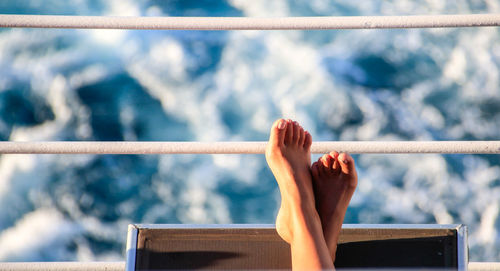 Low section of woman relaxing on boat
