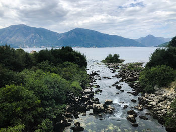 Scenic view of river amidst mountains against sky