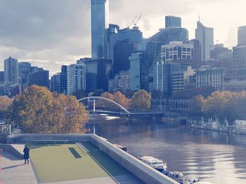 Lone figure in waterfront cityscape