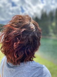 Rear view of woman looking at camera