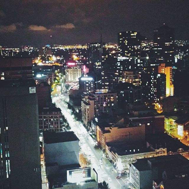 building exterior, architecture, night, illuminated, built structure, city, cityscape, high angle view, residential building, residential district, crowded, residential structure, city life, street, sky, road, tower, skyscraper, outdoors, dark