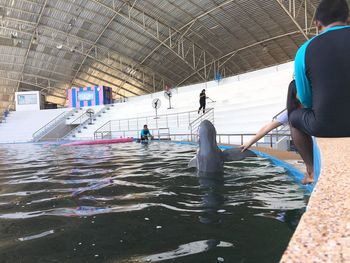 People standing by swimming pool