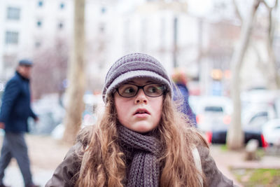Portrait of beautiful woman in city during winter