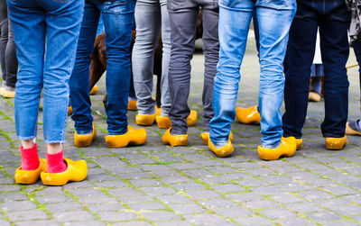 Low section of people standing on footpath