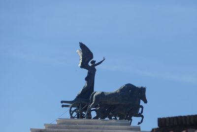 Low angle view of statue against sky