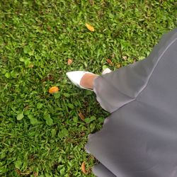 Low section of woman standing on grass