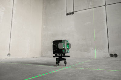 Laser level, construction, finishing work in the room. laser building level with green beams 