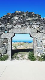 View of old wall against clear blue sky