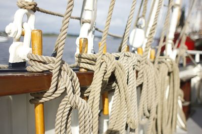 Close-up of rope tied on boat over lake