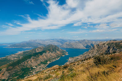 Scenic view of sea and mountains against sky