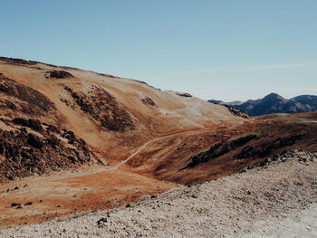 Scenic view of arid landscape against clear sky