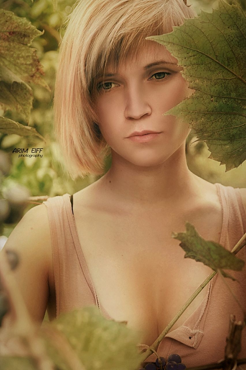 young adult, young women, beautiful woman, one person, real people, front view, lifestyles, fashion, plant, blond hair, portrait, leaf, close-up, leisure activity, looking at camera, beauty, outdoors, day, standing, tree, nature, one young woman only, people