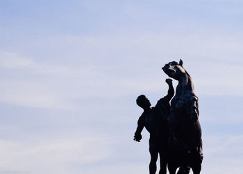 Low angle view of statue against sky