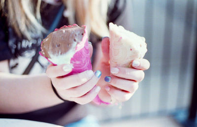 Midsection of woman holding ice cream cones