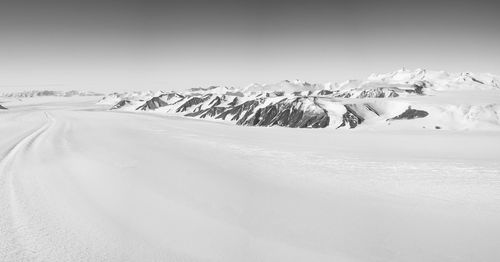 Snow covered landscape against sky