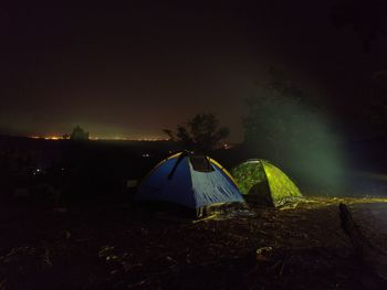 Tent on field against sky at night