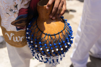 Hands holding percussion instrument. african music.