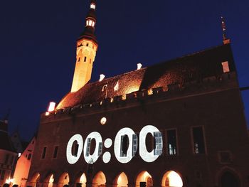 Low angle view of illuminated building against sky at night