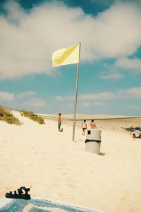 People on beach against sky