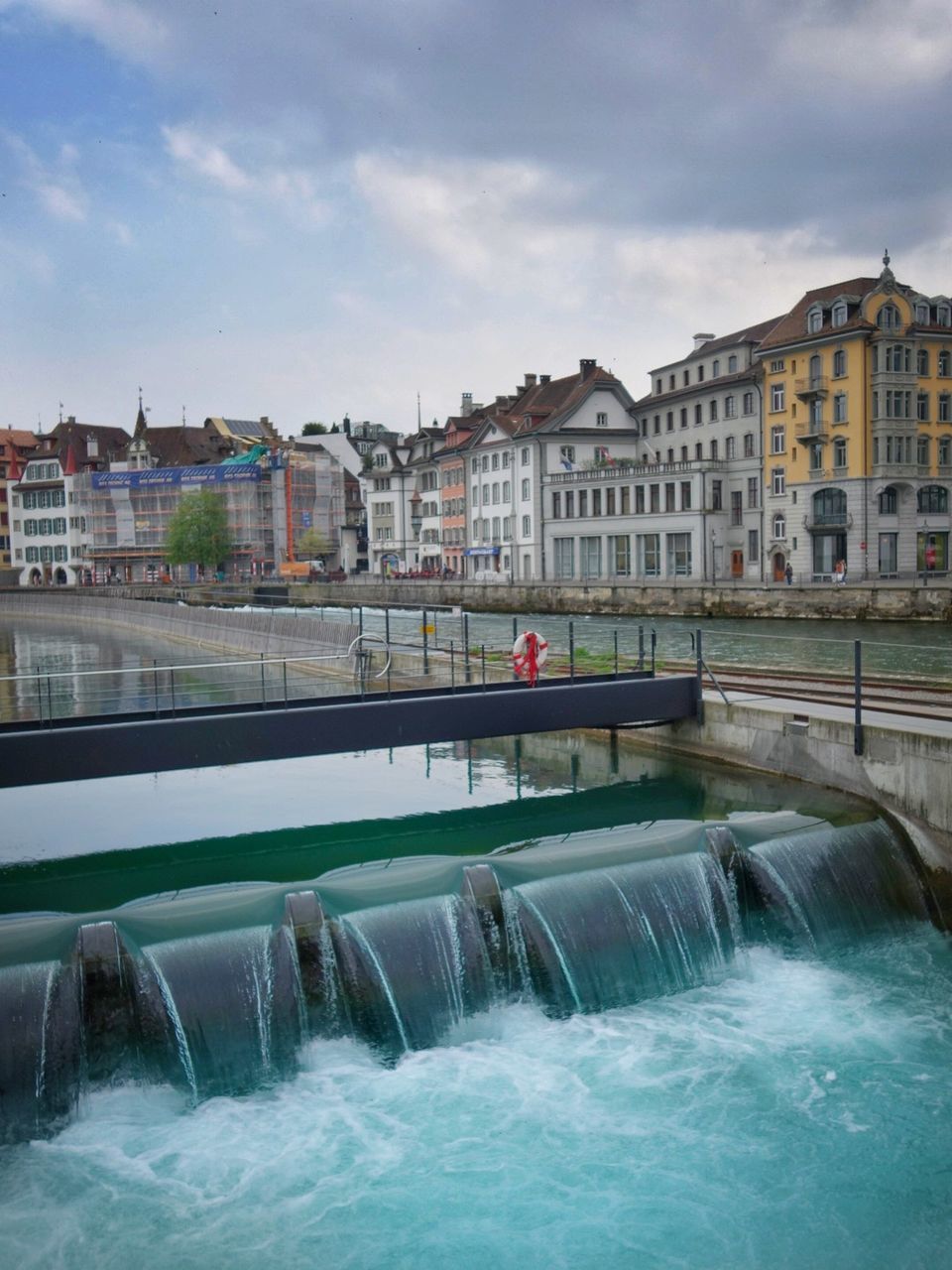 architecture, built structure, water, building exterior, sky, hydroelectric power, dam, day, river, motion, fuel and power generation, bridge - man made structure, cloud - sky, outdoors, no people, nature, city