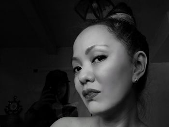 Portrait of young woman looking away at home