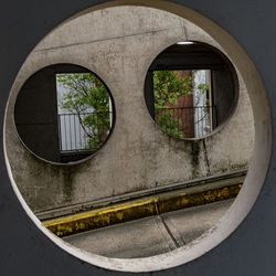 Circles in concrete, looking like a face. 