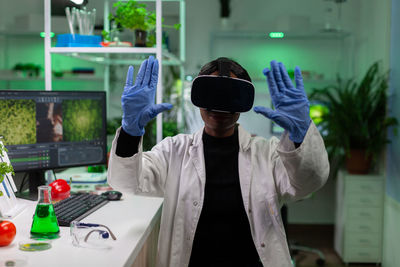 Scientist wearing virtual reality simulator at laboratory