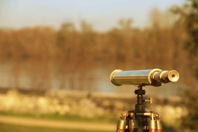 Close-up of coin-operated binoculars against sky