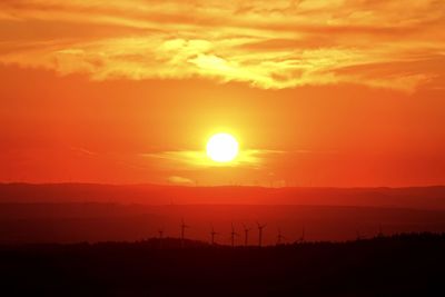 Scenic view of silhouette landscape against romantic sky at sunset