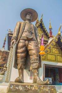 Low angle view of statue against temple building