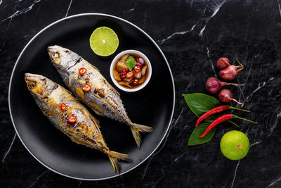 High angle view of fruits in plate on table