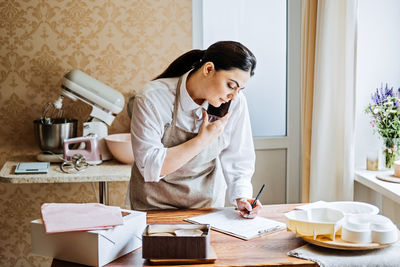 Small local business owner of confectionery, sweet-shop, pastry-shop. asian arabic woman pastry