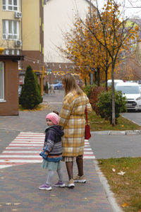 Rear view of women walking on street