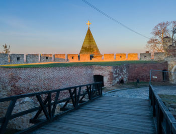 View of temple by building against sky