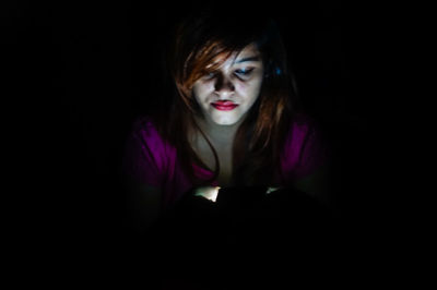 Beautiful young woman in darkroom