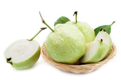 Close-up of fruits in basket against white background