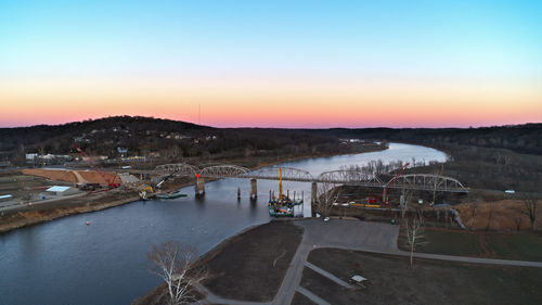 Scenic view of river against clear sky during sunset