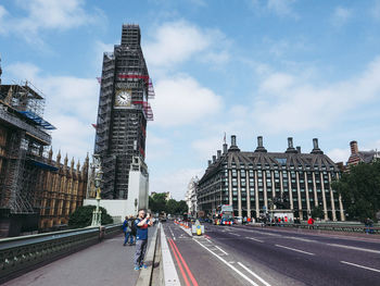 Low angle view of buildings against cloudy sky