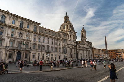 Group of people in front of buildings in city