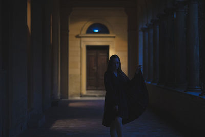 Woman walking in corridor of building