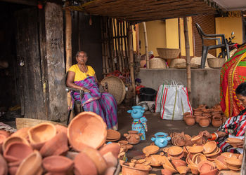 Man sitting at market stall