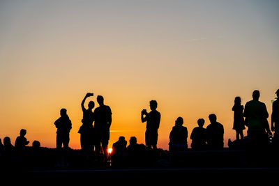 Silhouette people at sunset