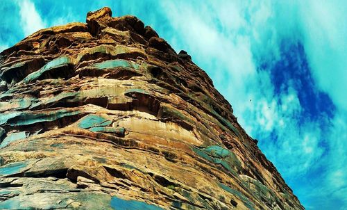 Low angle view of rock formation against sky