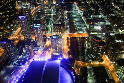 Aerial view of city lit up at night