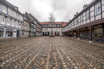 Street amidst buildings against sky