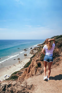 Rear view of woman on seashore
