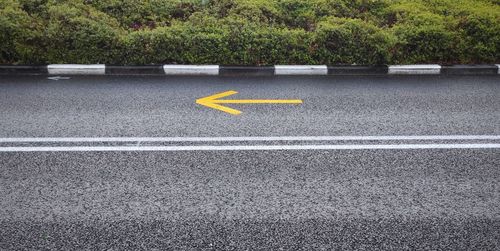 High angle view of road with yellow arrow