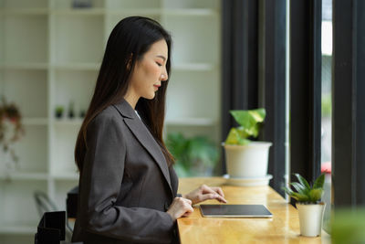 Businesswoman using digital tablet at office