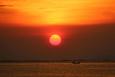 Scenic view of sea against romantic sky at sunset