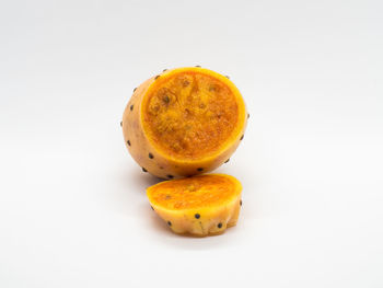 High angle view of orange fruit against white background